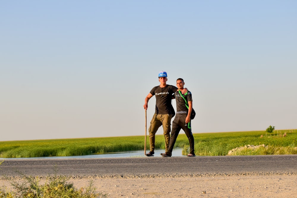 2 men running on road during daytime