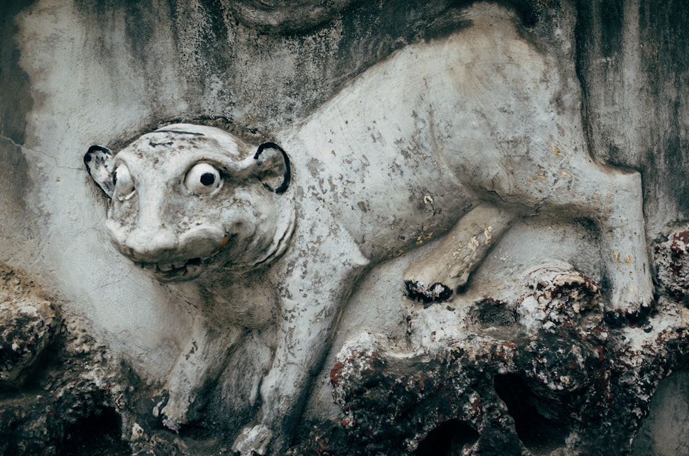 a statue of a cow laying on top of a rock