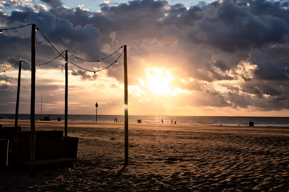 silhouette of person standing on beach during sunset