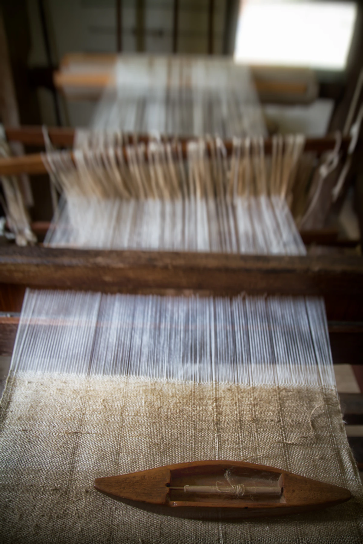 Close-up of textile weaving showing intricate colorful thread patterns