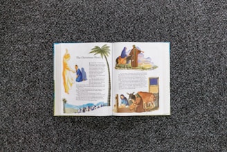 an open book with pictures of people and animals