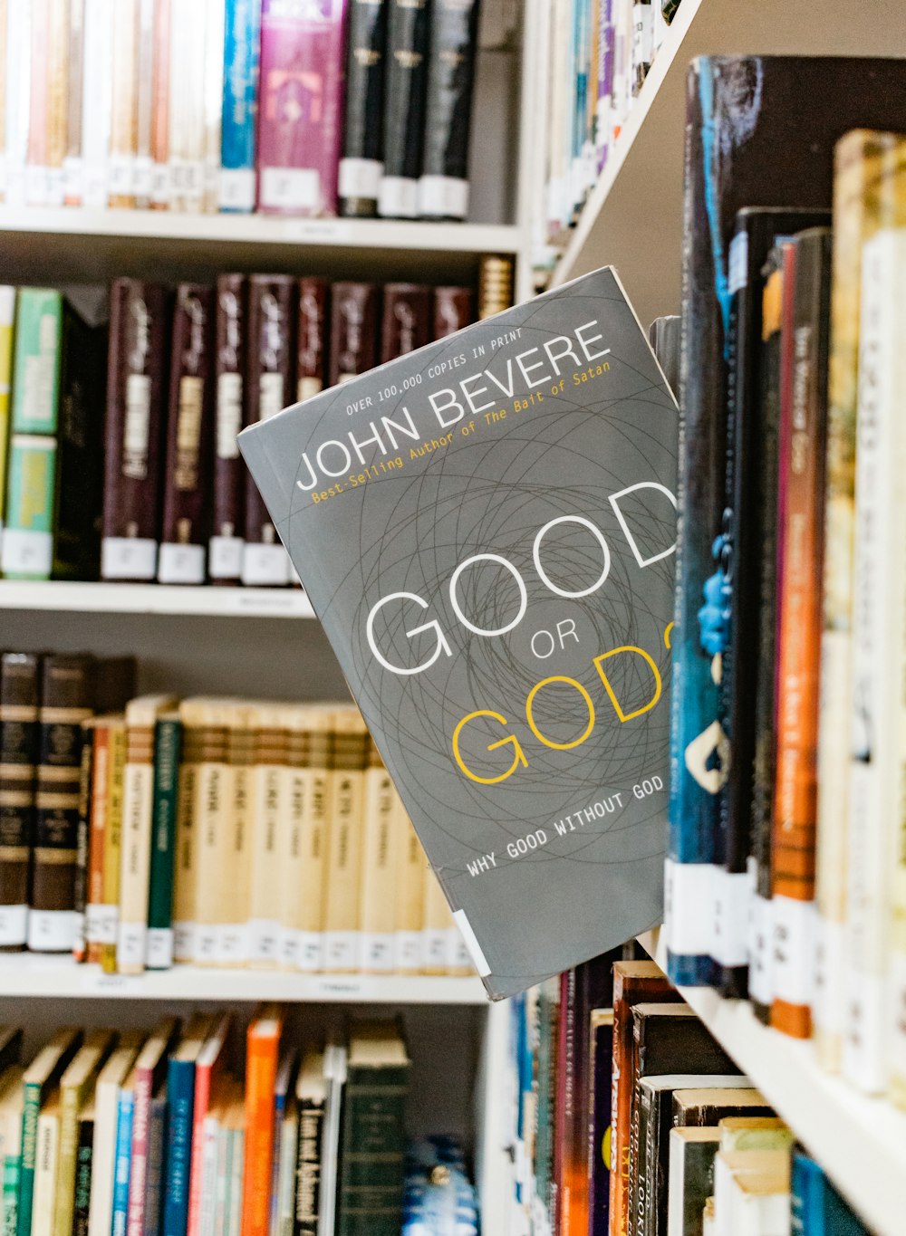 a book hanging from a book shelf in a library