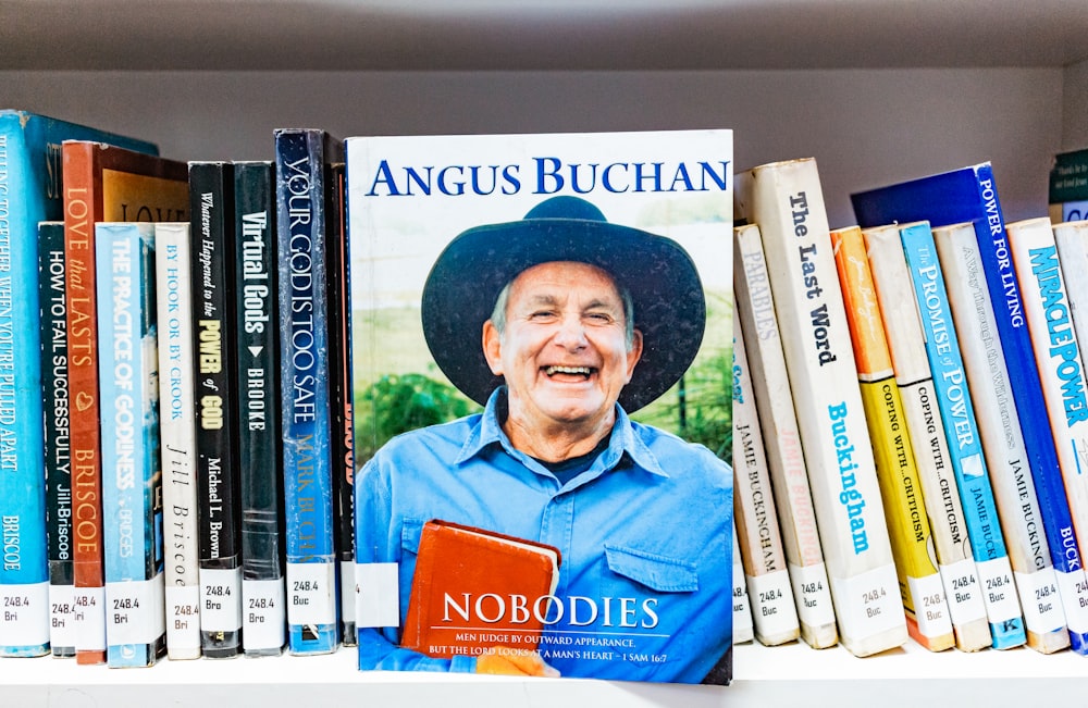 man in blue polo shirt wearing black hat