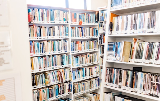 white wooden book shelves with books