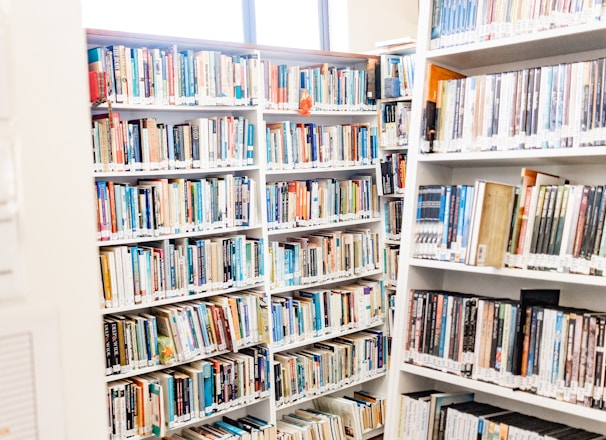 white wooden book shelves with books