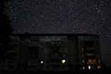 Evening shot of the apartment building glowing softly under the stars.
