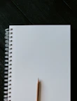 white spiral notebook on black wooden table