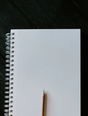 white spiral notebook on black wooden table