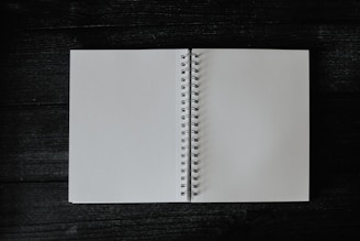 an open notebook on a wooden table