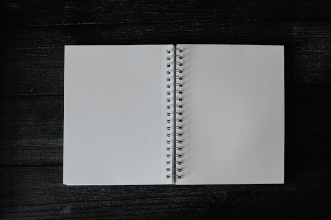 an open notebook on a wooden table
