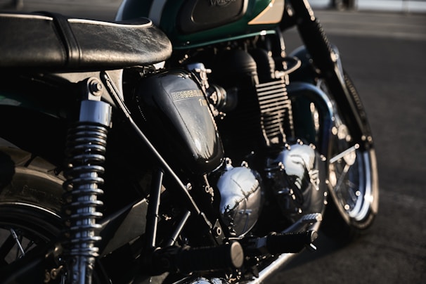 Close-up of a classic motorcycle engine gleaming in the afternoon light during a club ride.