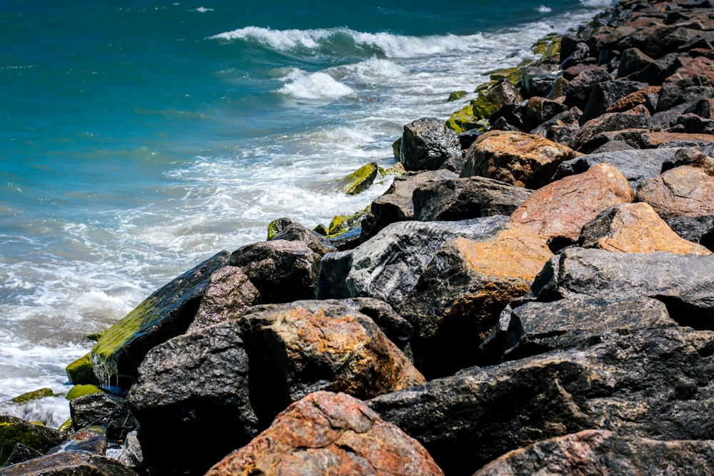 a bunch of rocks that are by the water