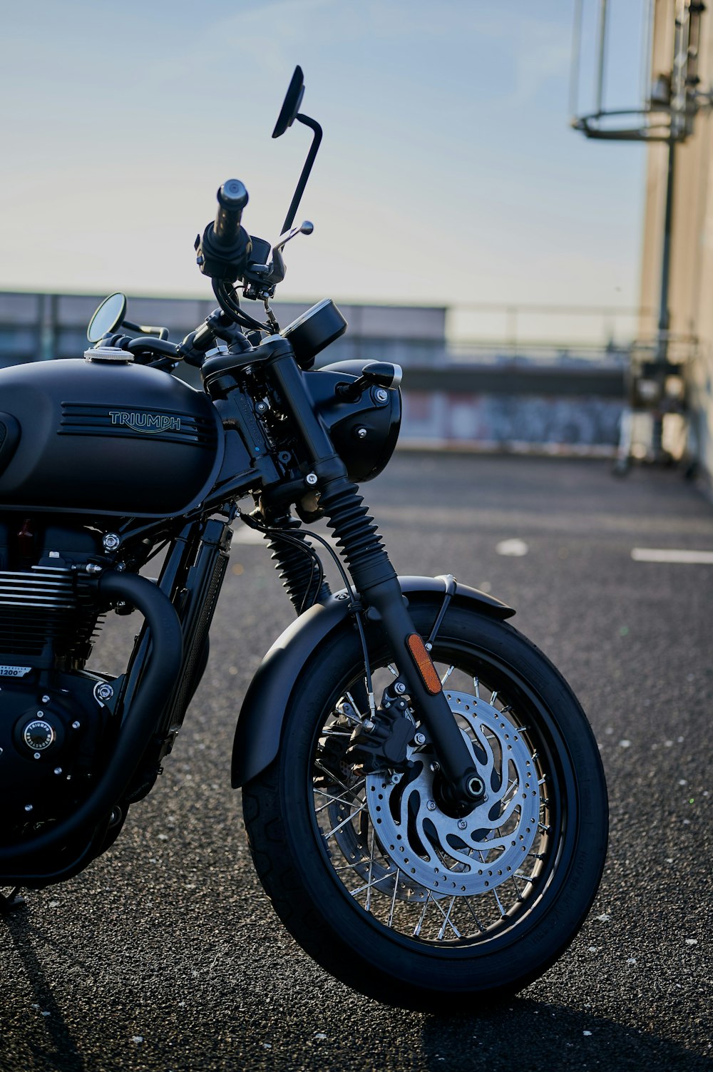 a black motorcycle parked in a parking lot