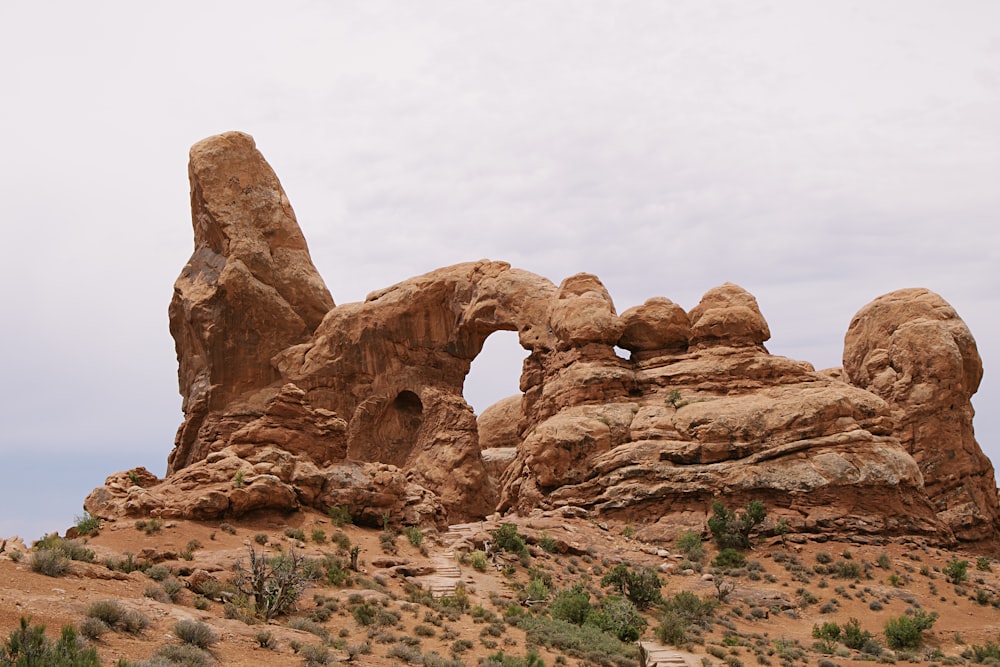 brown rock formation under white sky during daytime