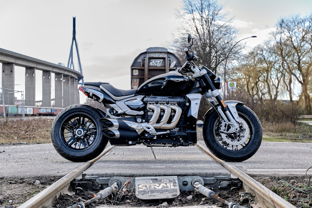 black and blue sports bike parked on gray concrete road during daytime