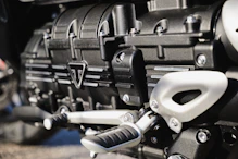 Close-up of a sleek, high-performance engine part gleaming under soft lighting.