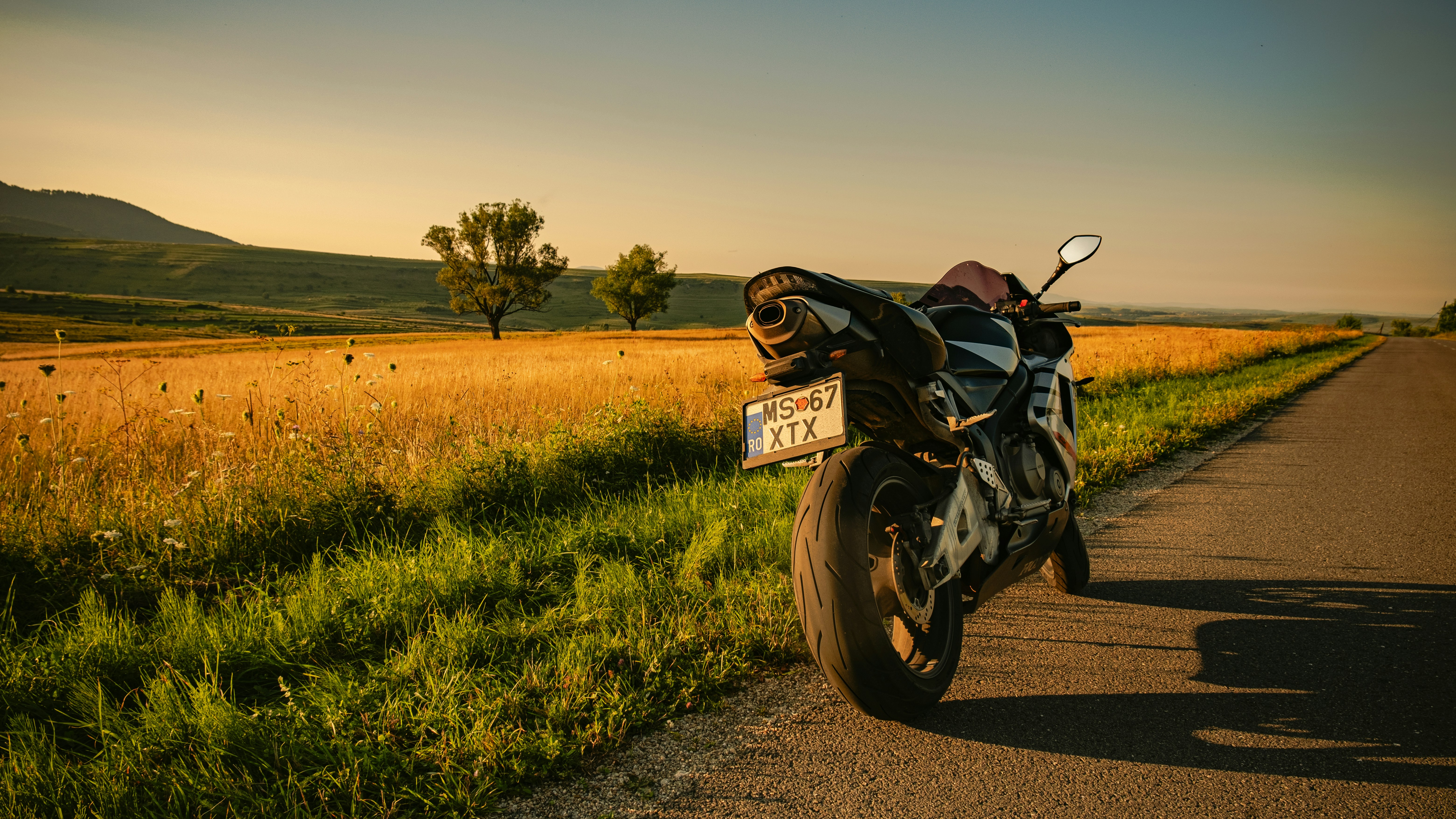 black motorcycle on green grass field during daytime