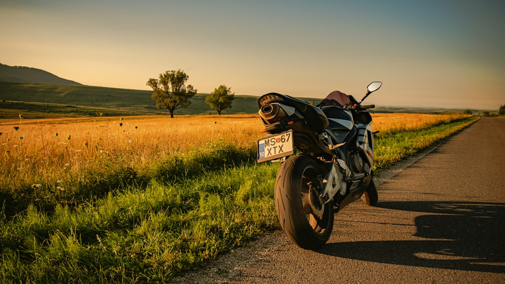 black motorcycle on green grass field during daytime