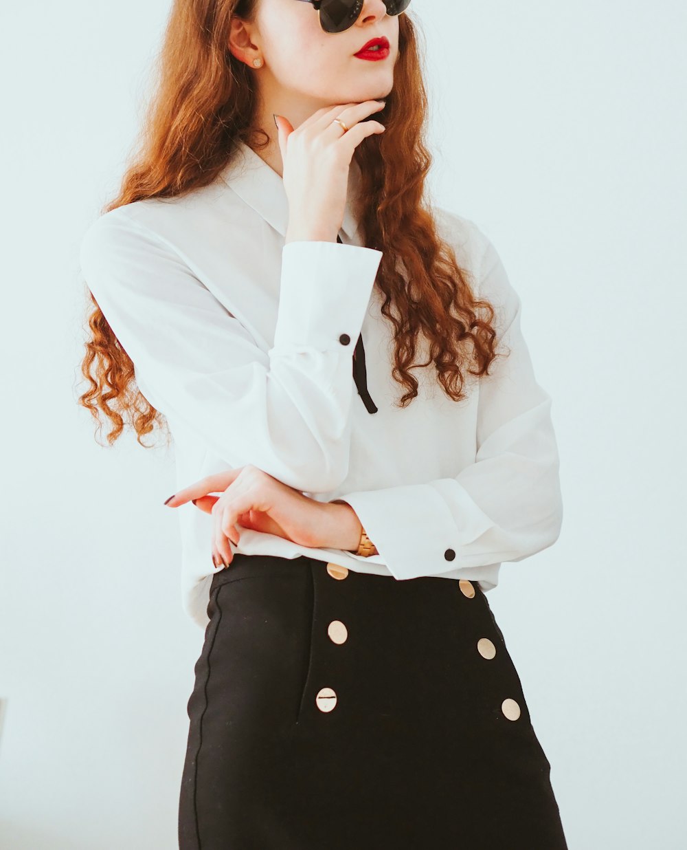 woman in white blazer and black and white polka dot skirt