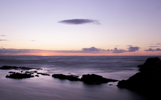 silhouette of rocks on sea shore during sunset in Gotland Sweden