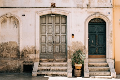 brown wooden door on white concrete building
