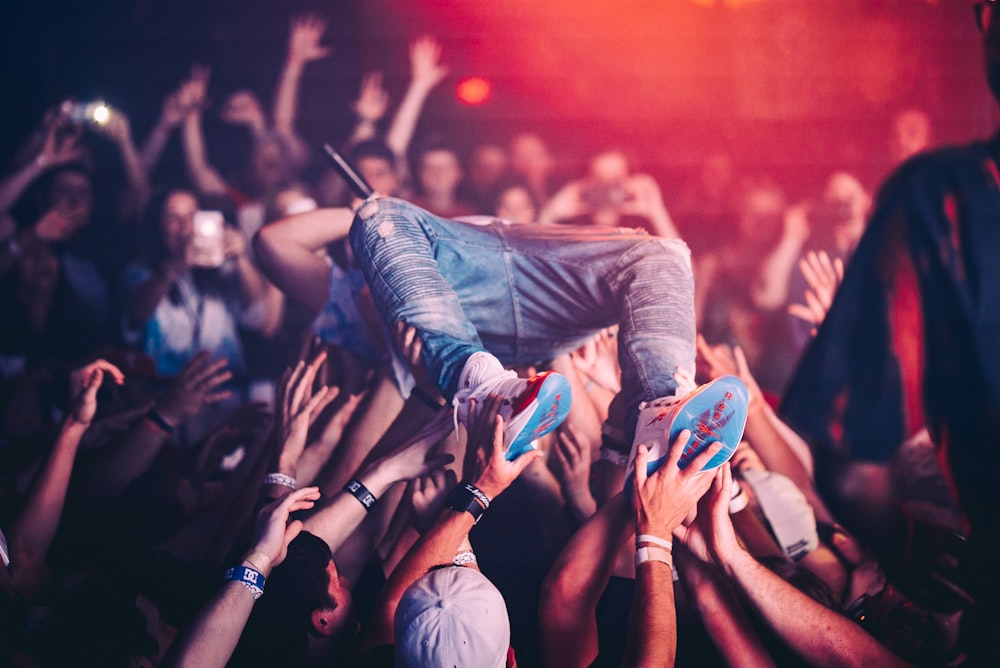 people raising their hands with blue paint