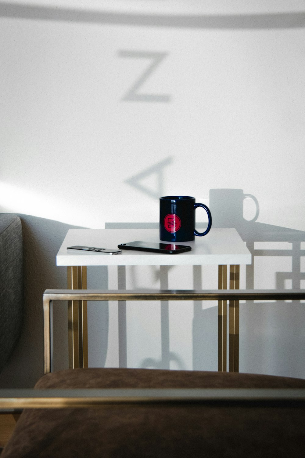 black and red ceramic mug on white wooden table