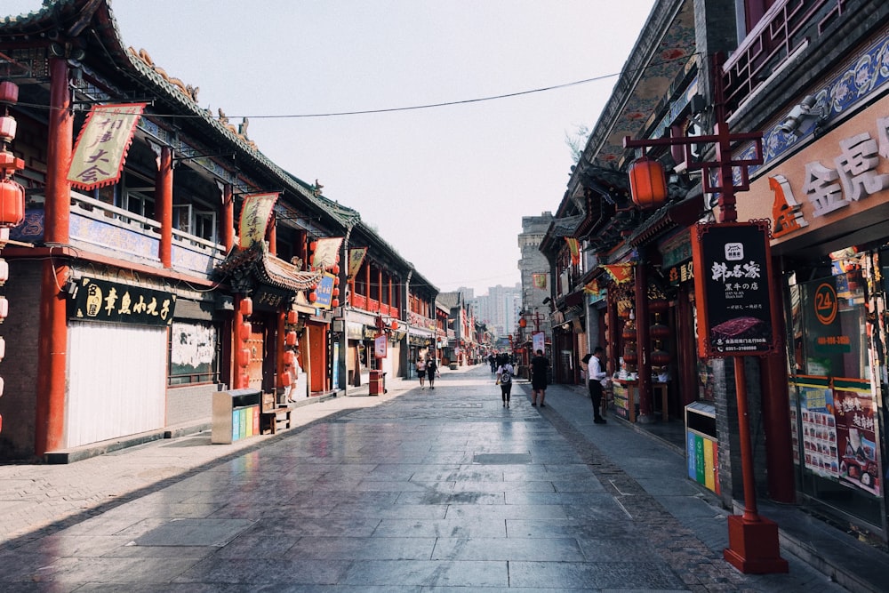 people walking on street between buildings during daytime