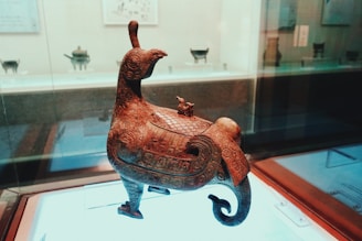 Brass sculpture of a small animal with fine surface detail.