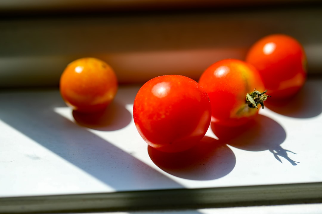 orange tomato on white table