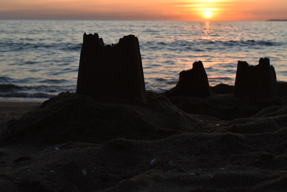 rock formation on sea during sunset