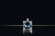 clear glass perfume bottle with black background