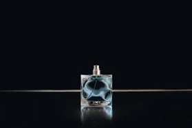 clear glass perfume bottle with black background