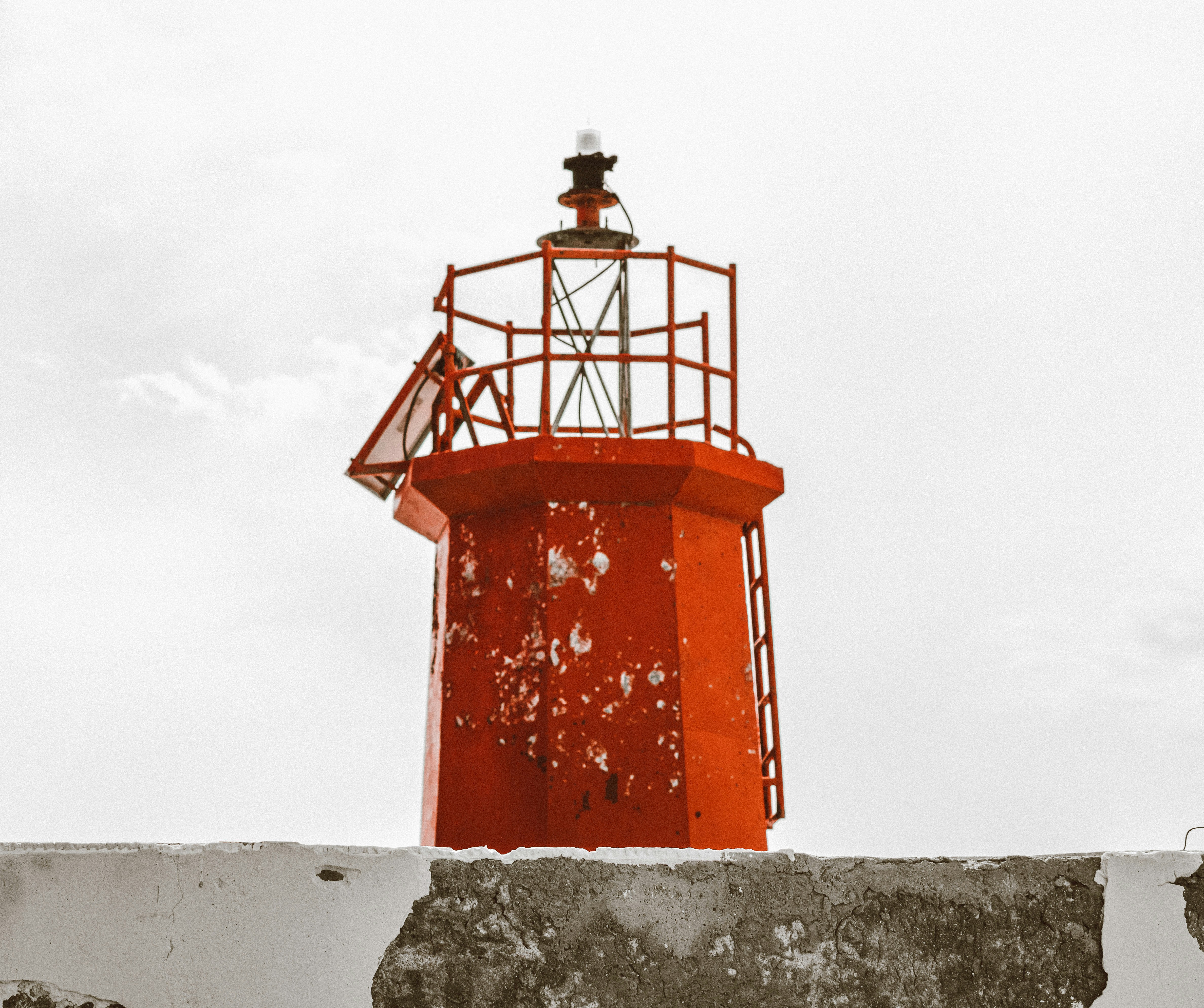 red and white concrete lighthouse under white sky during daytime in Bodegas in Do