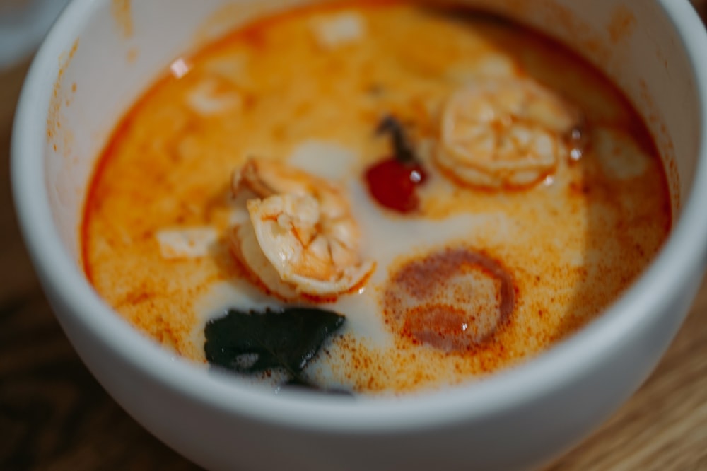 soup with sliced of meat in white ceramic bowl