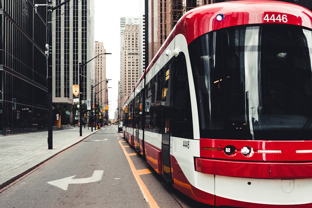 red and white tram on road during daytime