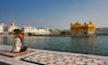 white and brown ship on sea near brown and white building during daytime