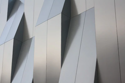 Architectural blueprint alongside custom-cut aluminum panels ready for installation.