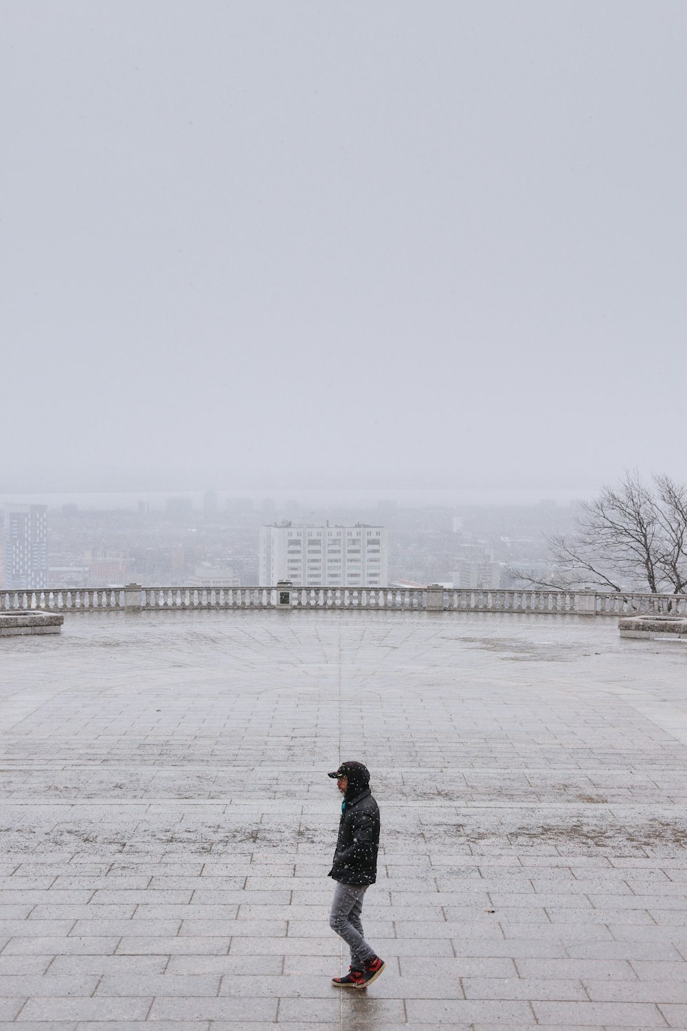 person in black jacket walking on snow covered field during daytime