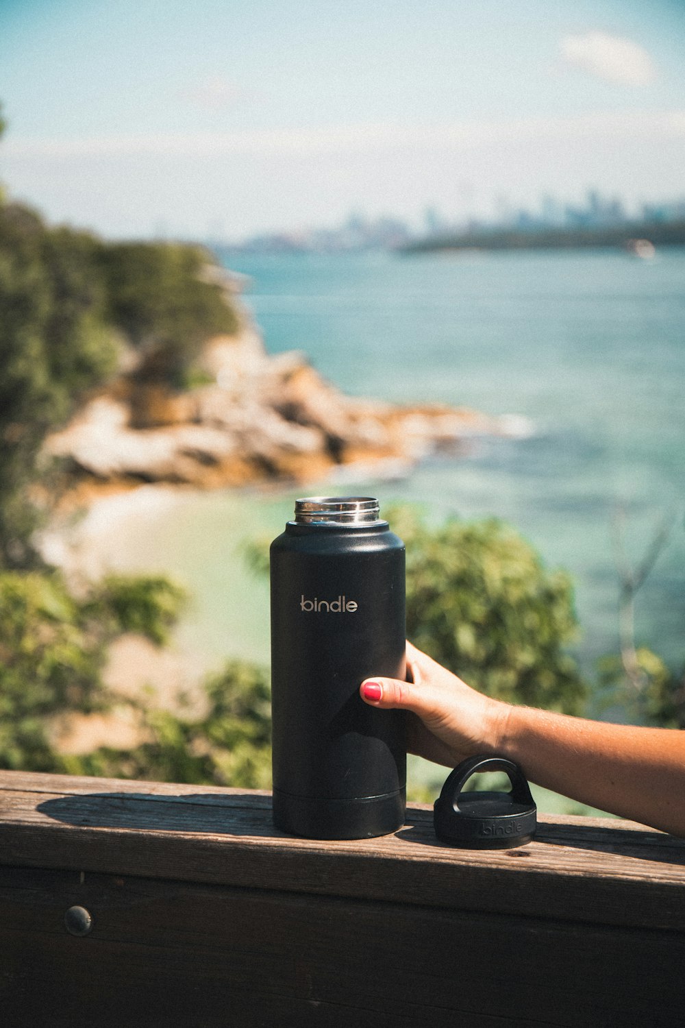 person holding black and silver tumbler