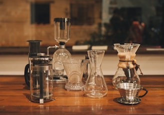 clear glass pitcher on brown wooden table