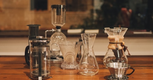 clear glass pitcher on brown wooden table