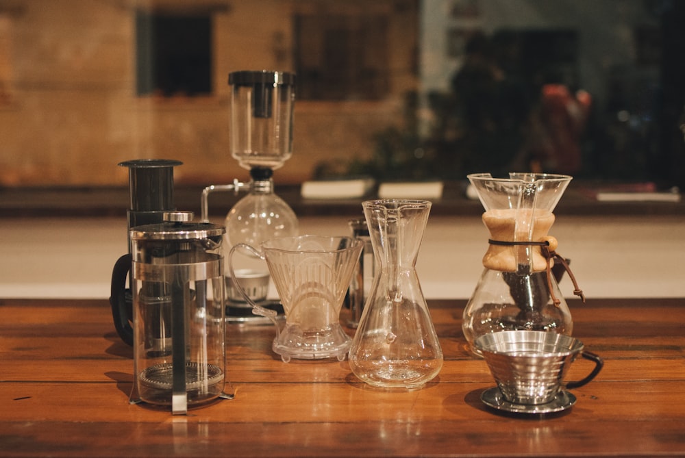 clear glass pitcher on brown wooden table