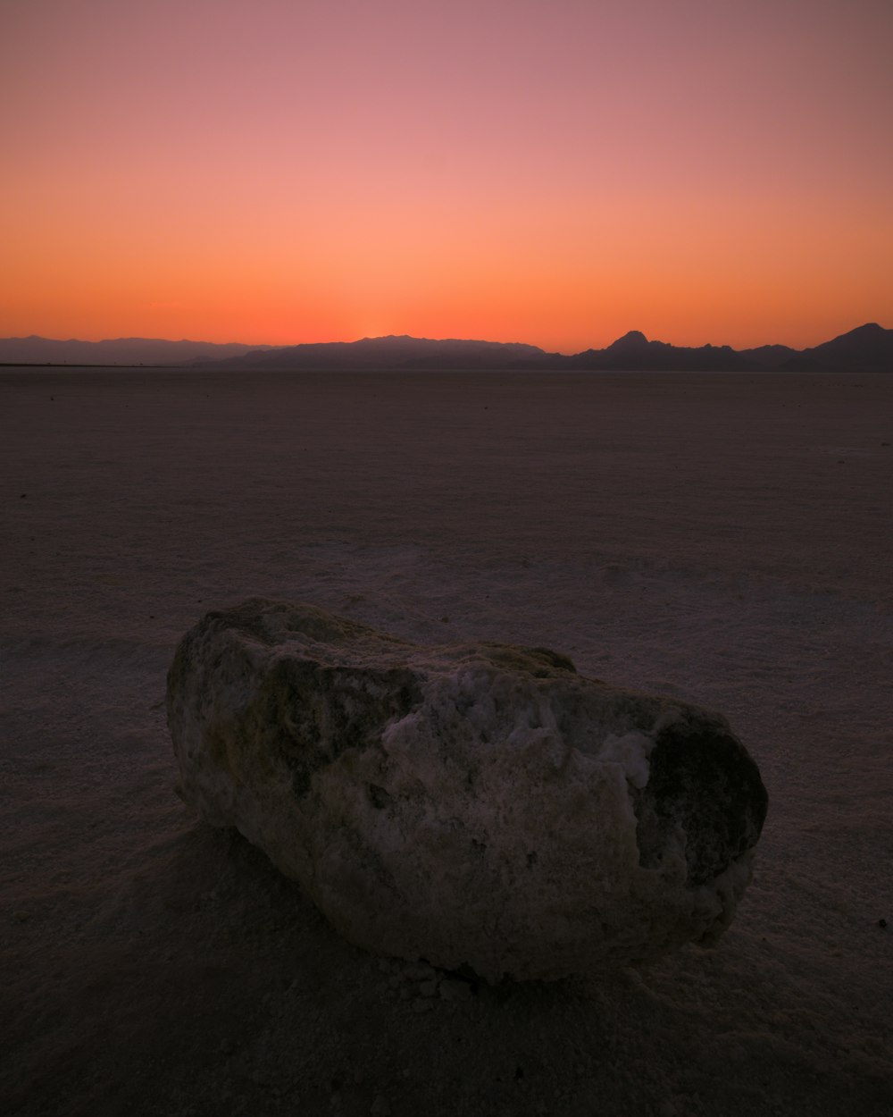 gray rock formation on sea during sunset