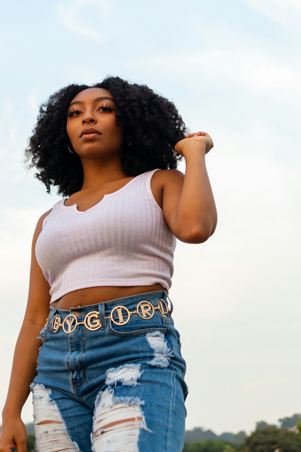 woman in white tank top and blue denim shorts