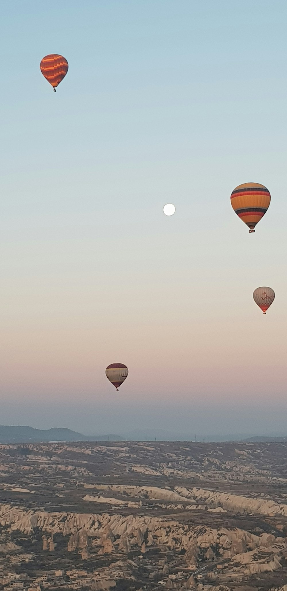 hot air balloons in the sky during sunset