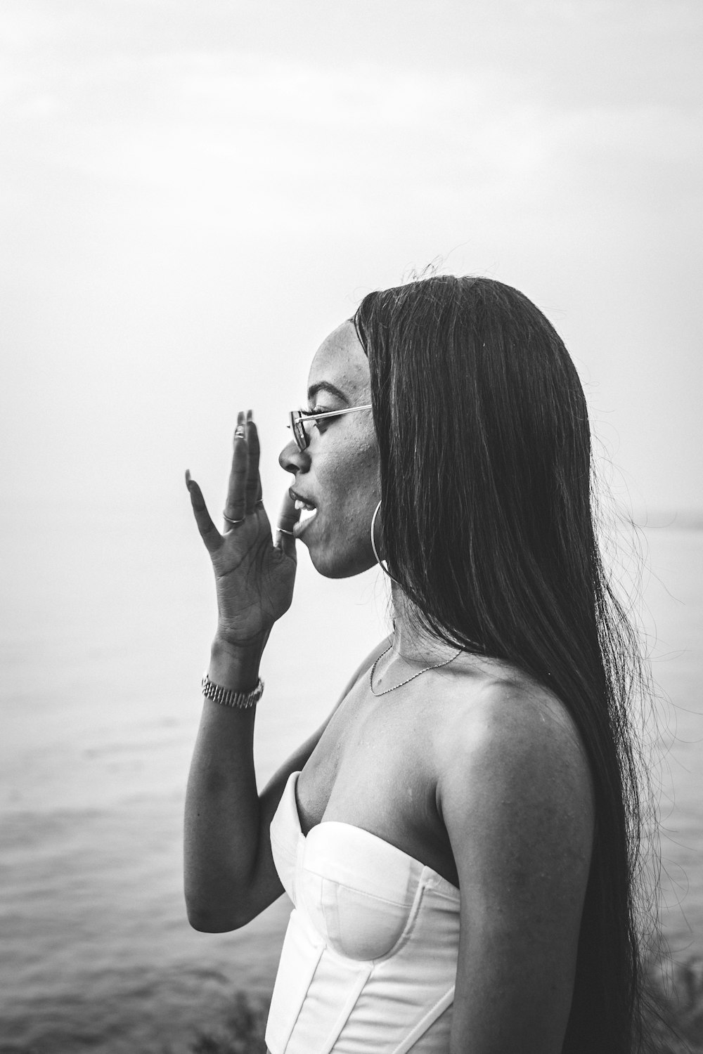 woman in white brassiere wearing eyeglasses