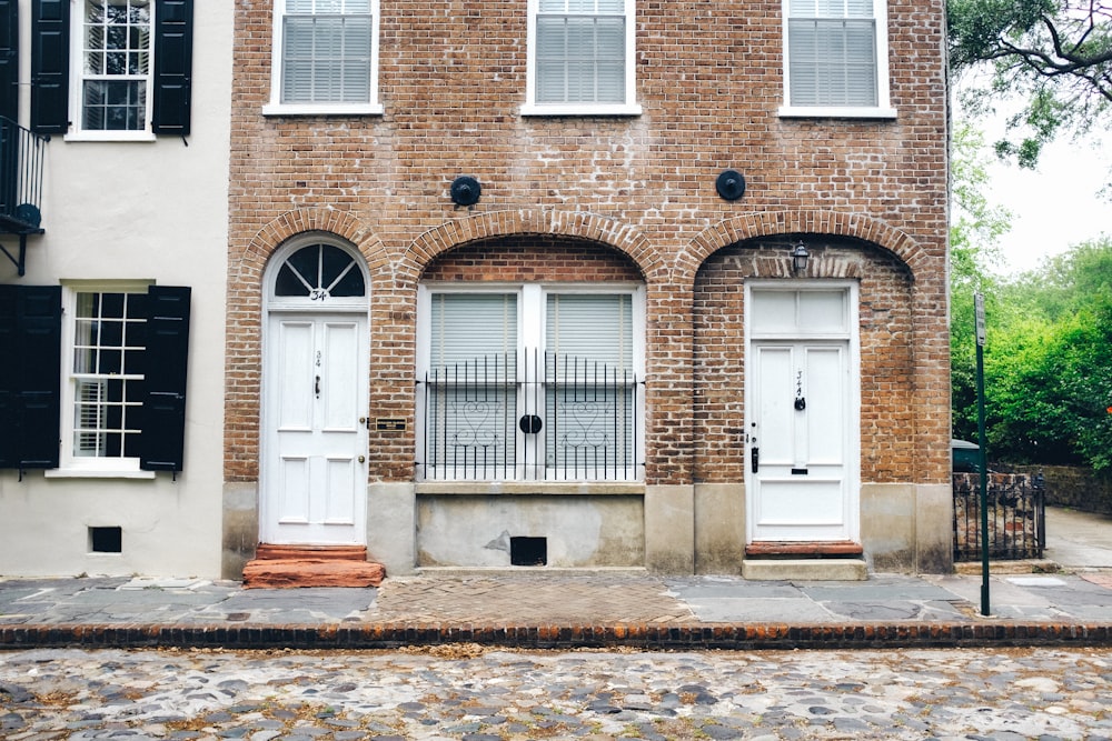 brown brick building with white wooden door