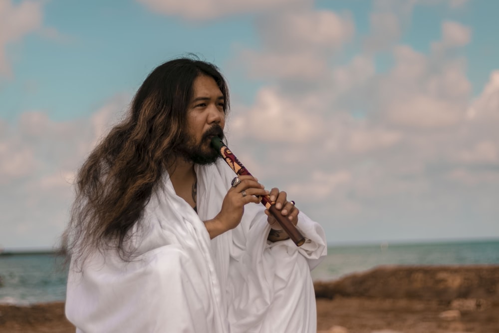 woman in white dress shirt playing flute