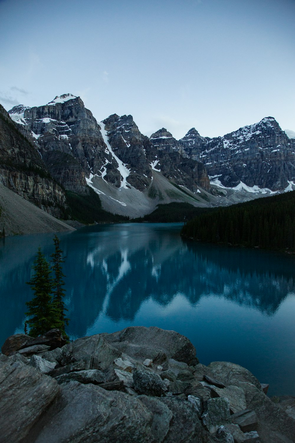 lake surrounded by mountains during daytime